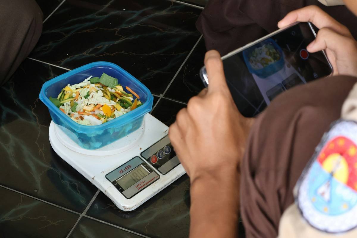 Woman using digital scale to learn how to weigh your food for accurate calorie tracking
